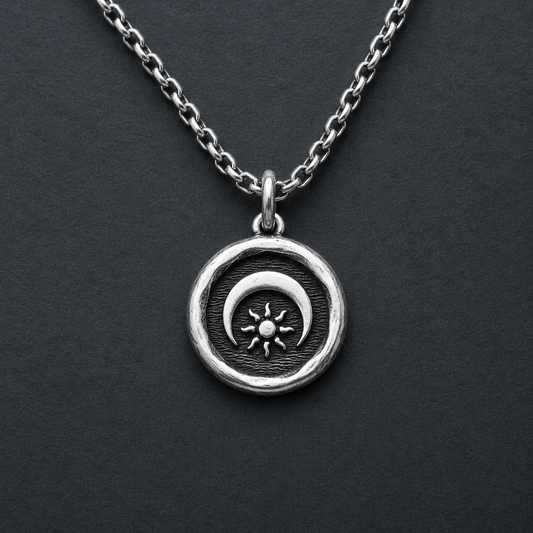 Silver necklace with a sun and moon pendant