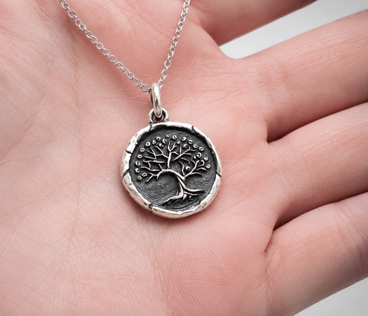 Sterling silver pendant with Tree of Life design on hand