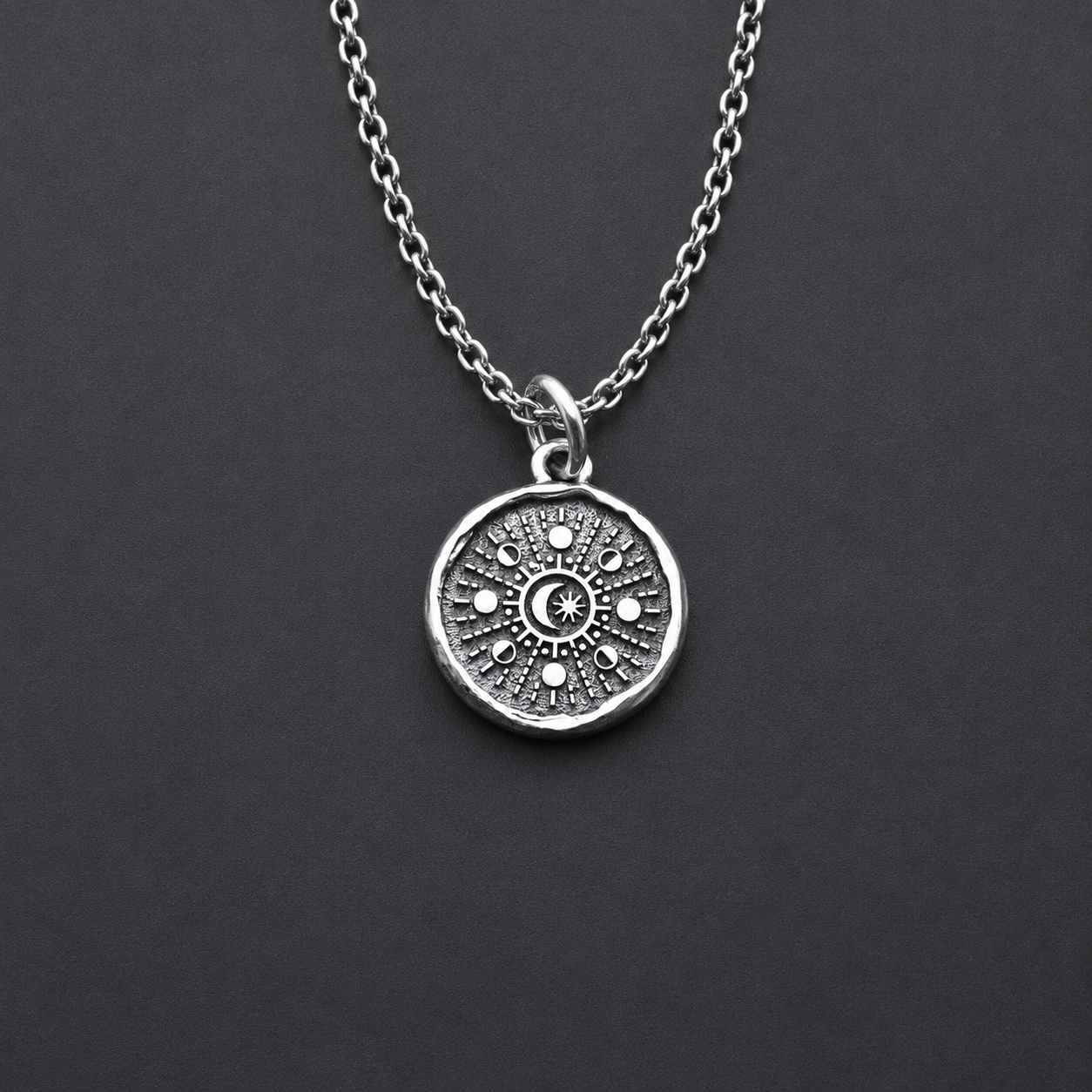 Sterling silver pendant with moon phases design 