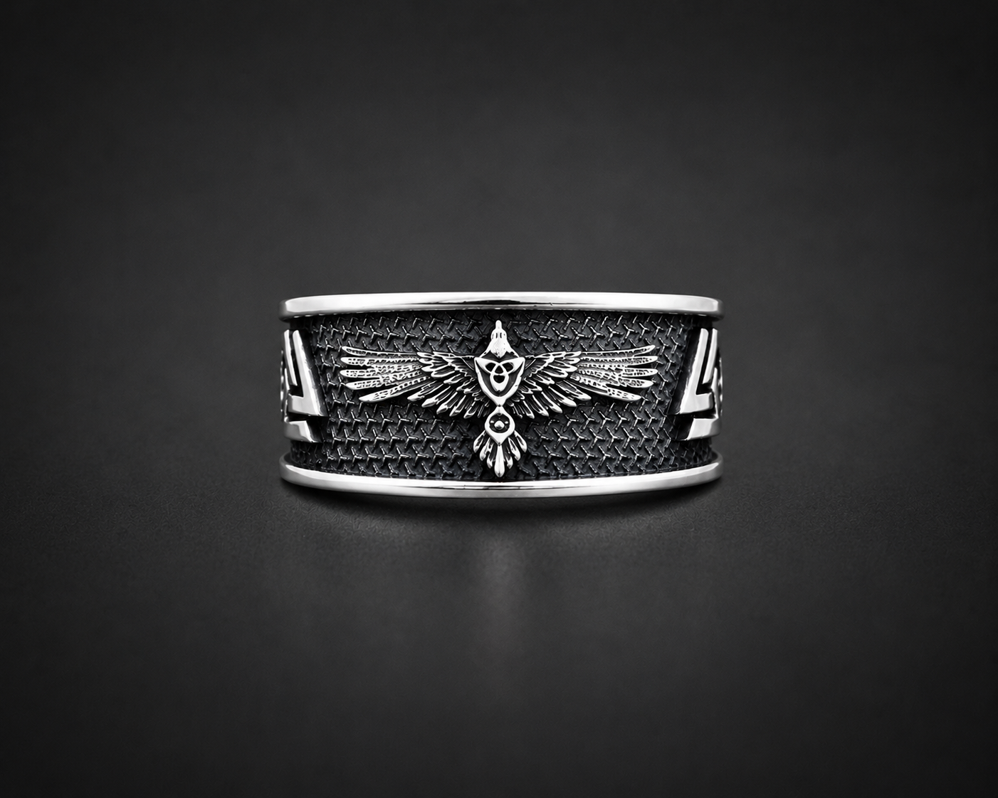 A sterling silver ring with a raven Norse mythology design on hand