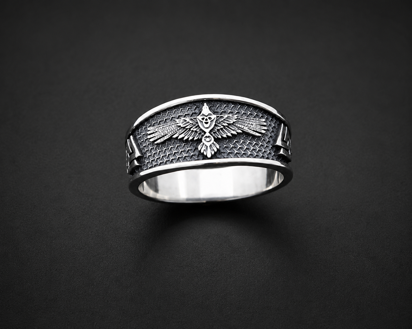 A sterling silver ring with a raven Norse mythology design