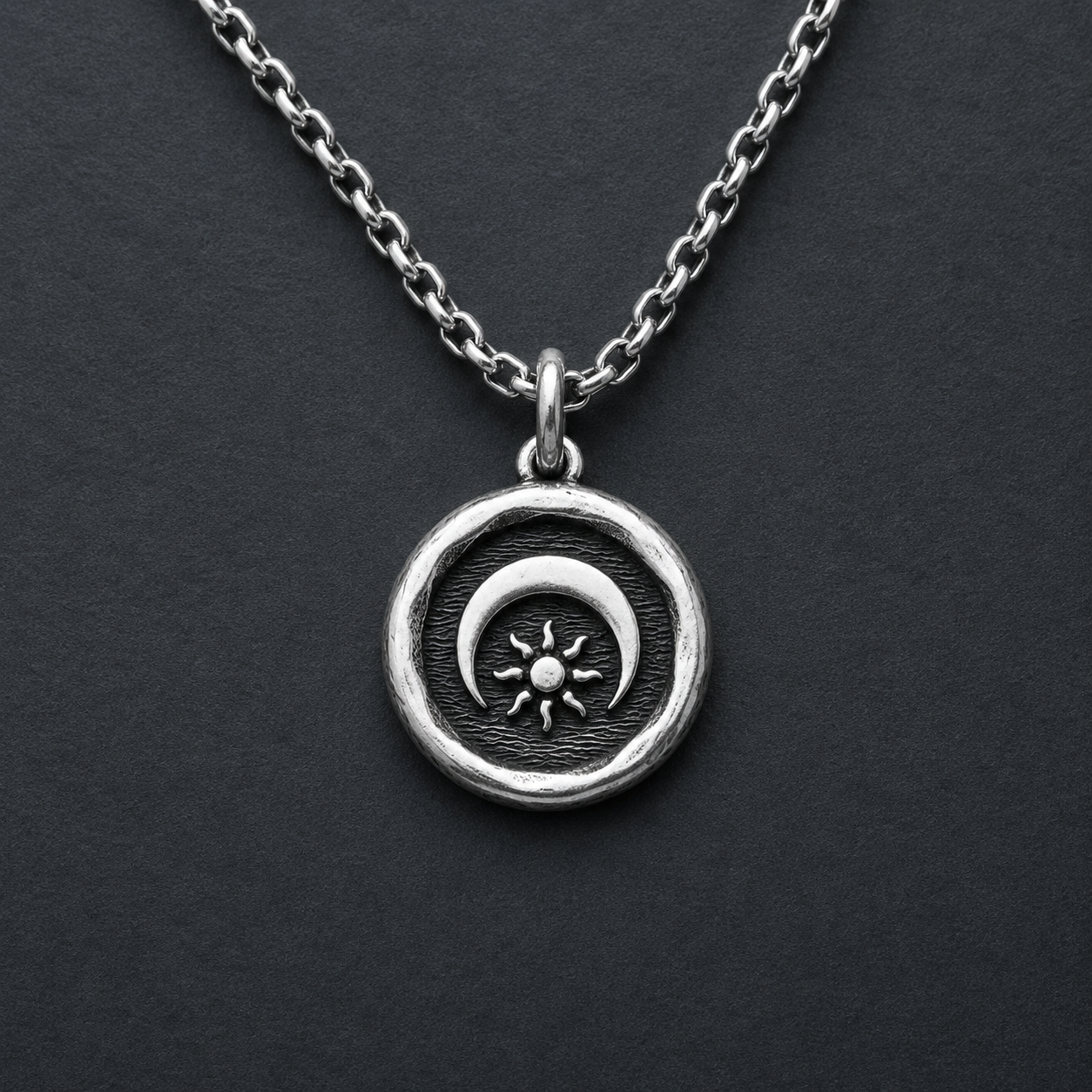 Silver necklace with a sun and moon pendant
