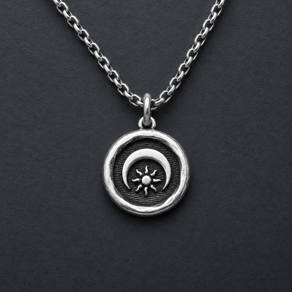 Silver necklace with a sun and moon pendant