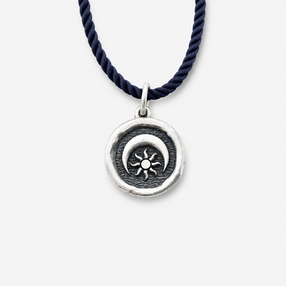Sterling silver pendant with sun and moon design