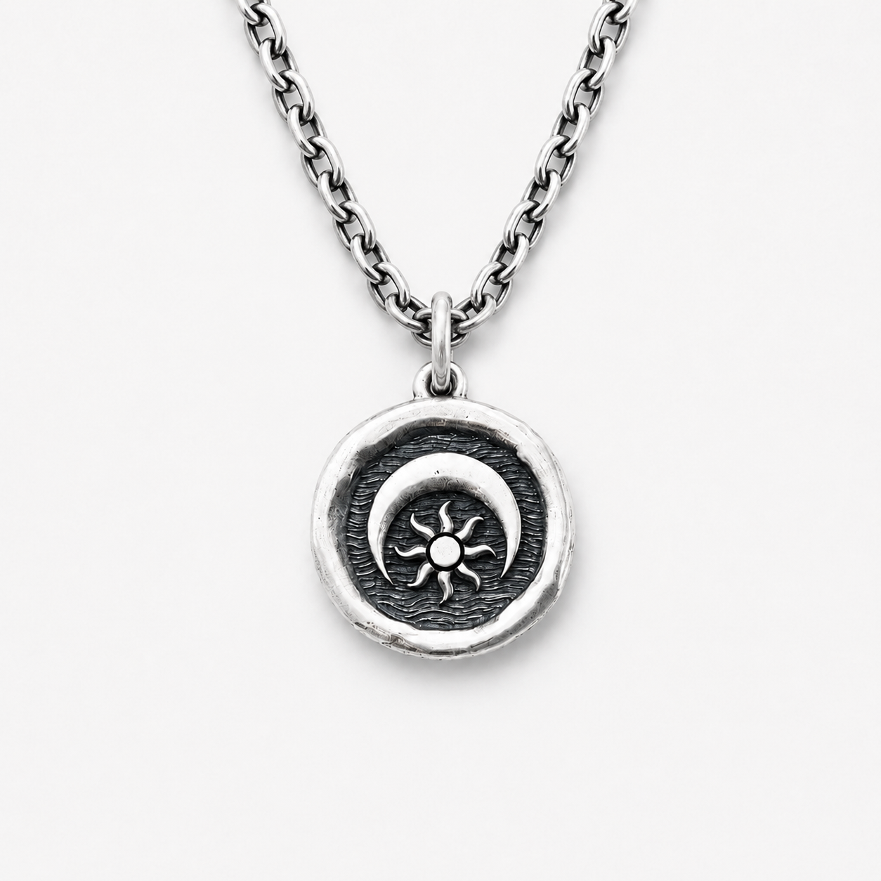 Silver necklace with a sun and moon pendant