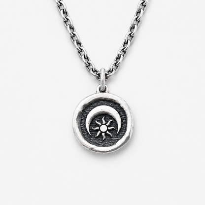Silver necklace with a sun and moon pendant